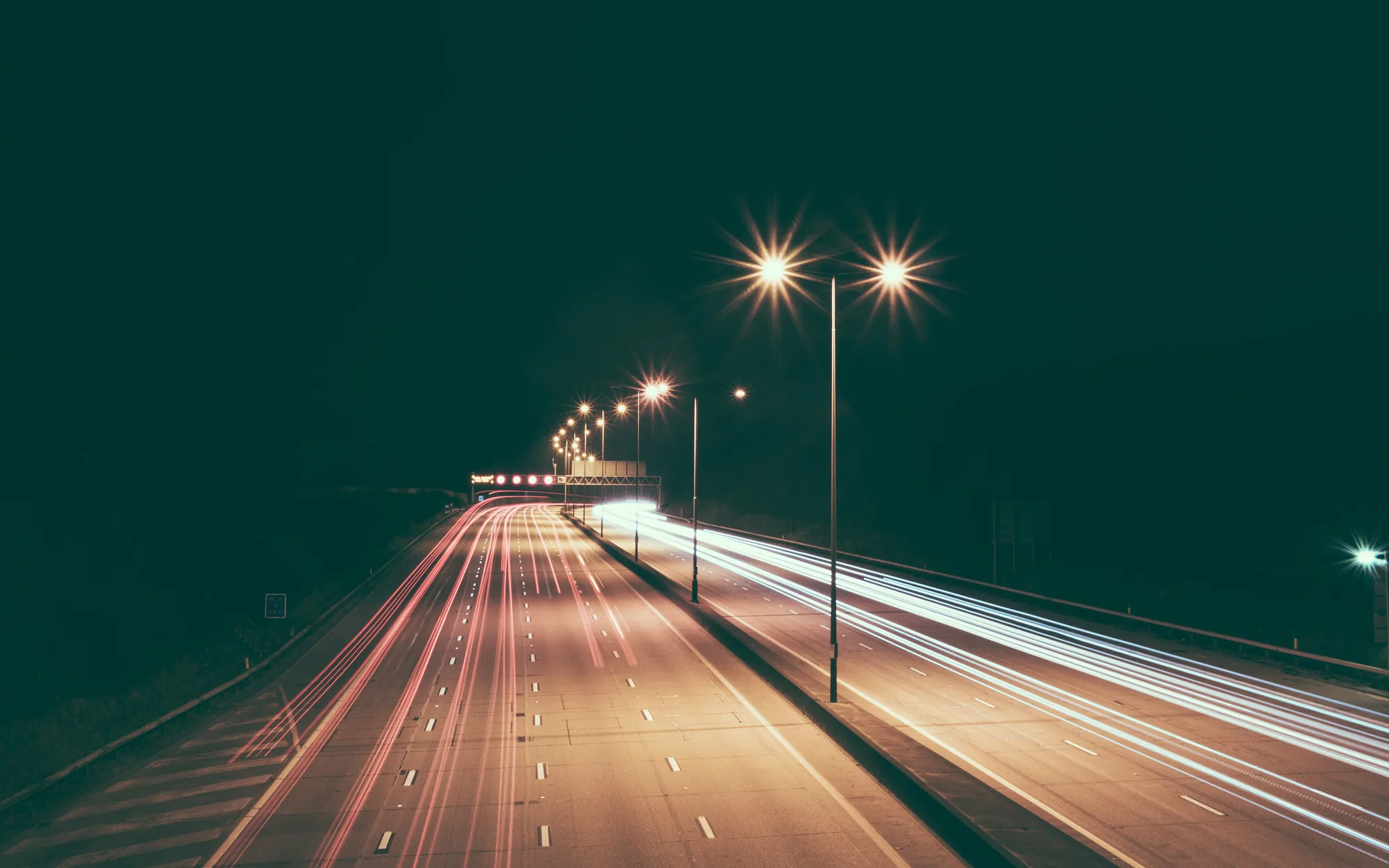 Long-exposure trucks on a night highway